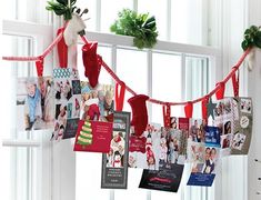 christmas cards are hanging on a window sill