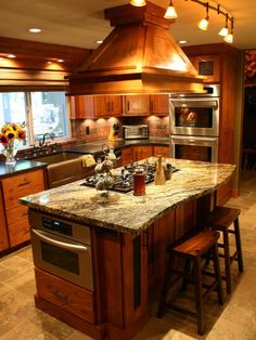 a large kitchen with an island in the middle