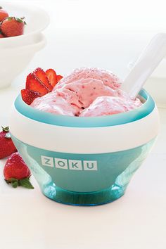 a bowl filled with ice cream and strawberries