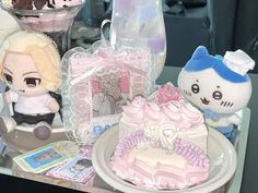 a table topped with cakes and stuffed animals