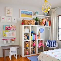 a child's bedroom with toys and decor on the walls, including bookshelves