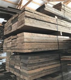 stacks of wooden planks stacked on top of each other in a warehouse or building