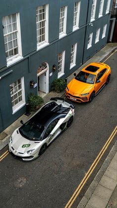 two cars parked next to each other in front of a building