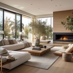 a living room filled with furniture and a fire place in the middle of an open floor plan