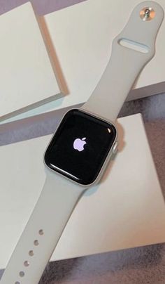 an apple watch sitting on top of a white box