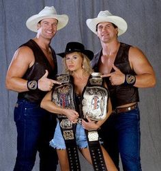 two men and a woman in cowboy hats posing for the camera