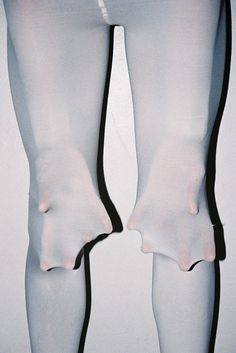 the legs and ankles of a woman in white stockings