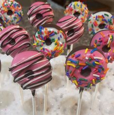 there are many donuts with sprinkles on top of the cake pops