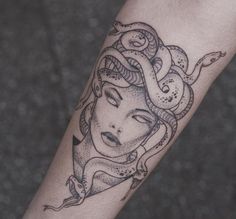 a woman's arm with a tattoo on it and an octopus around her neck