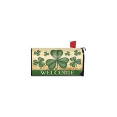 a welcome sign with four leaf clovers on it