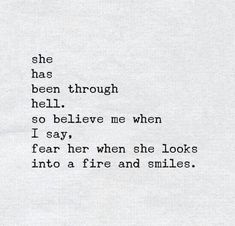 an old typewriter with the words she has been through hell, so believe me when i say i fear her when she looks into a fire and smiles