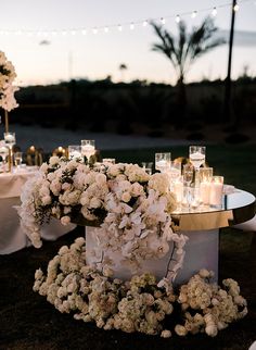 a table with flowers and candles on it