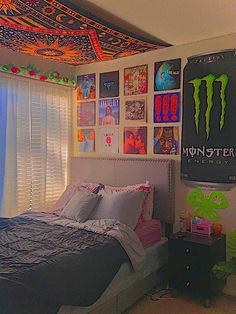 a bed room with a neatly made bed and monster posters on the wall above it