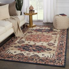 a living room filled with furniture and a rug