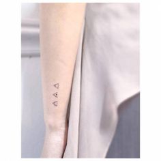 a person with a small tattoo on their arm and the word'love'written in cursive font