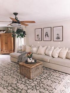 a living room filled with furniture and a ceiling fan in the middle of the room