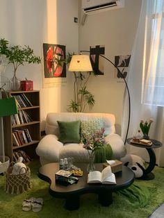 a living room filled with furniture and lots of green rugs on top of a floor