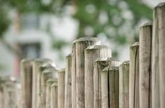 a wooden fence that is next to a house