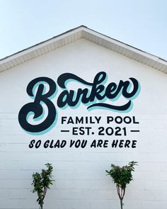 a sign on the side of a building that says baker family pool - est 2091 so glad you are here