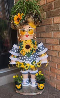 a doll with sunflowers on her head and sunglasses