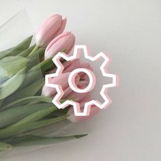 a bouquet of tulips with a cogwheel cut out in the middle