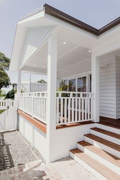 a white house with wooden steps and railings