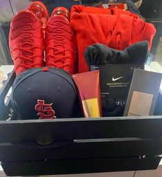 a hat, baseball cap and other items are sitting in a shoe box on display