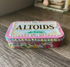 an altoids tin sitting on top of a wooden table