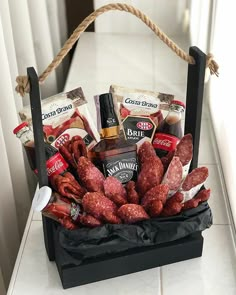 a basket filled with hot dogs and condiments on top of a white counter