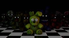 a green teddy bear sitting on top of a black and white checkered floor