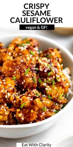 crispy sesame cauliflower in a white bowl with rice and garnish