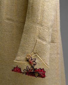 a close up of a person wearing a jacket with flowers on it