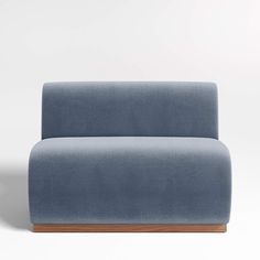 a blue couch sitting on top of a white floor