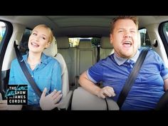 a man and woman sitting in the back seat of a car with their mouths open