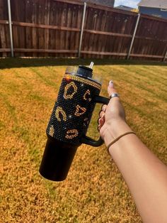 a person holding a coffee cup in their hand with the word love spelled on it