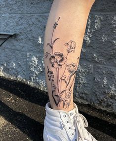 a woman's leg with flowers on it