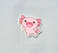 a pink sticker with an image of a little pig on it's back