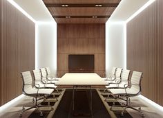 an empty conference room with white chairs and a long table in front of a flat screen tv