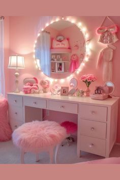 a bedroom with pink furniture and lights on the mirror above it is decorated in white