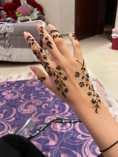 a woman's hand with black flowers on it