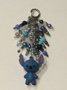 the stitcher charm is attached to a keychain with beads and charms on it