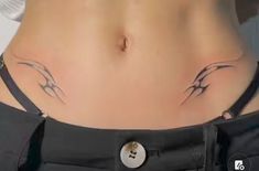 a woman's stomach with two birds on it and a button in the middle