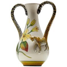 a ceramic vase with a giraffe and flowers painted on the side, in front of a white background