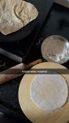 two uncooked pizza doughs sitting on top of a stove