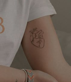 a person with a heart tattoo on their arm