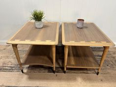 two wooden tables with plants on top of them