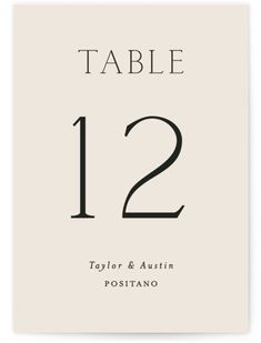 a table number card with the numbers twelve and twelve in black ink on white paper