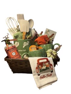 a basket filled with cooking utensils and other kitchen items next to a tea towel