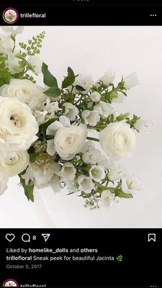 a bouquet of white flowers sitting on top of a table