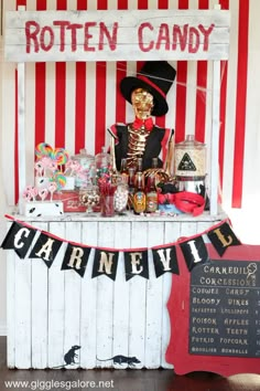 a table with candy, candies and an old fashioned sign that says rotten candy